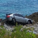 Car crashes onto ironshore in East End